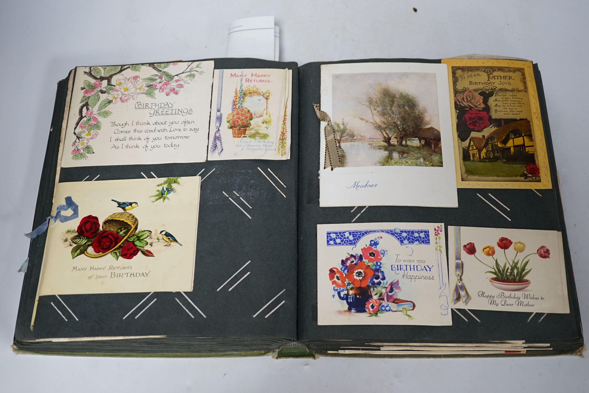 A vintage postcard album including greetings cards. Condition - fair